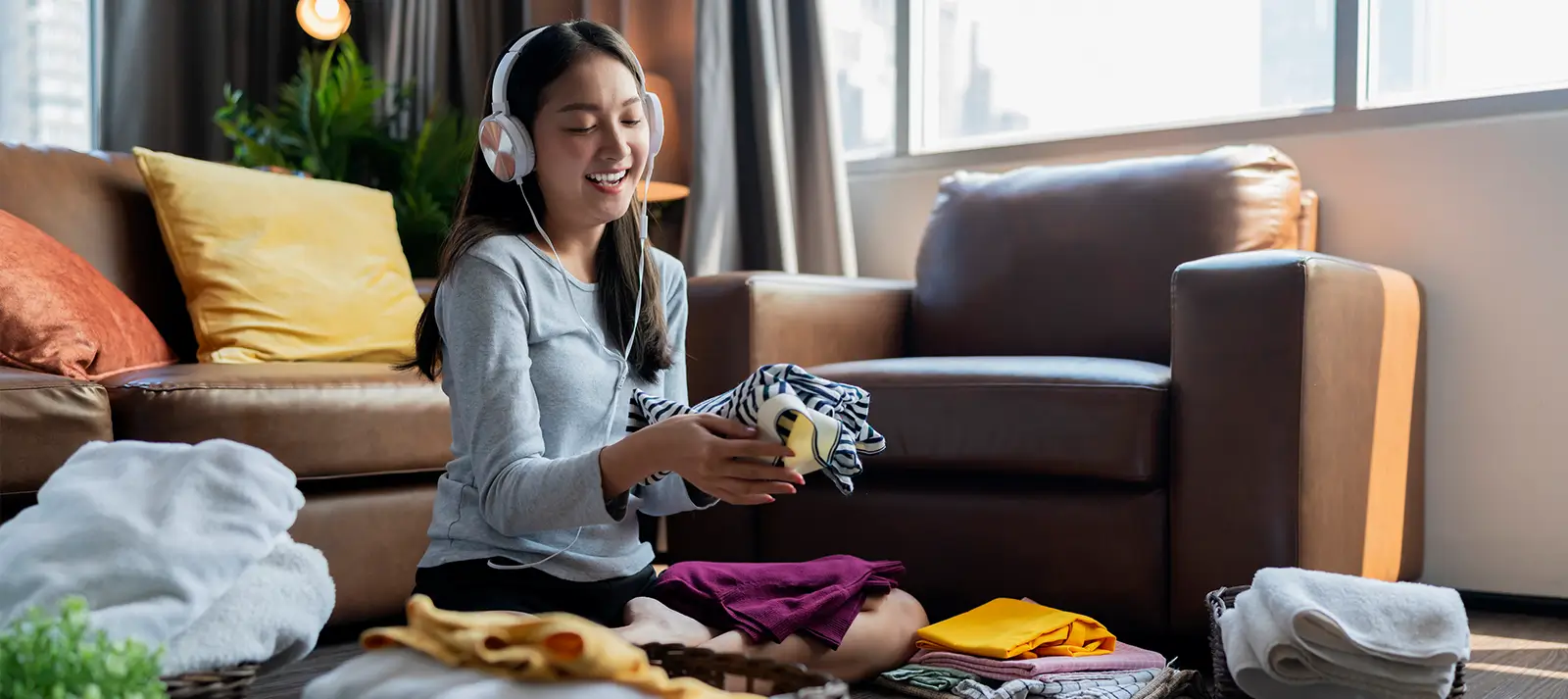 young woman folding laundry
